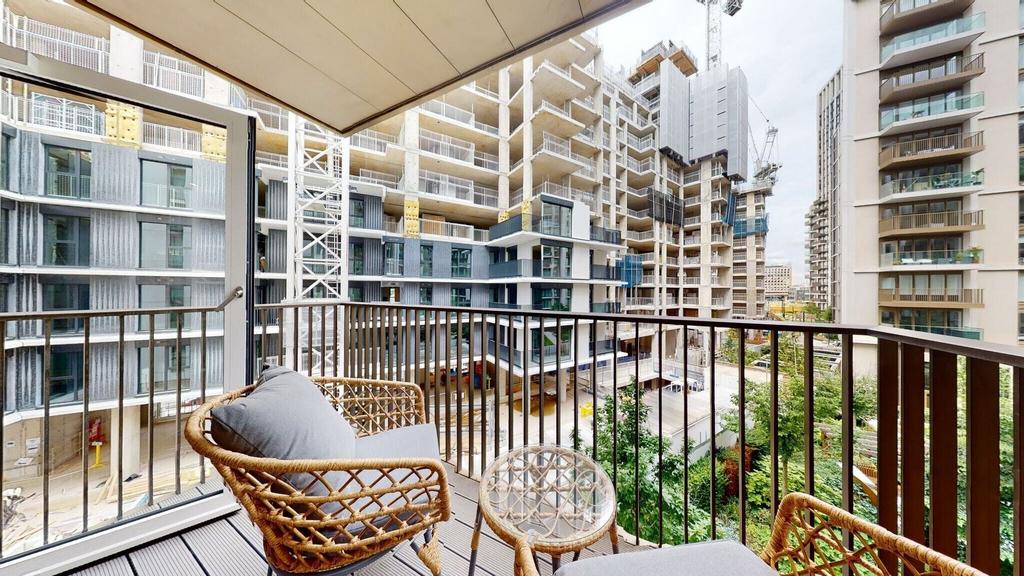 Sunny private balcony with seating and city vie...