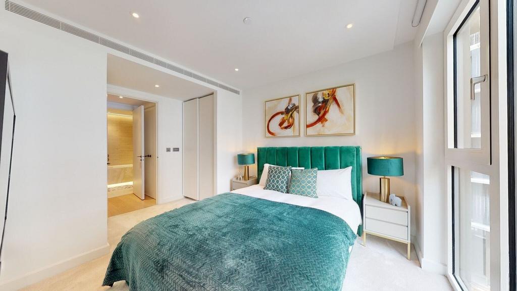 Bright double bedroom with elegant teal accents...