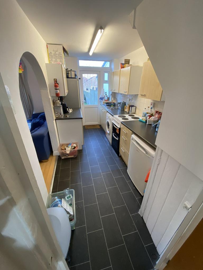 Bright galley kitchen with a straight run of li...