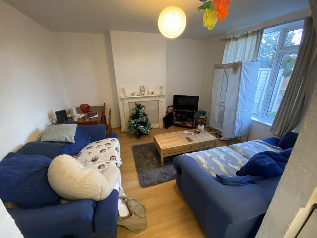 Bright, well-furnished living room with two com...