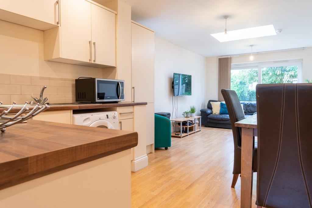 Bright open-plan living and kitchen area with w...