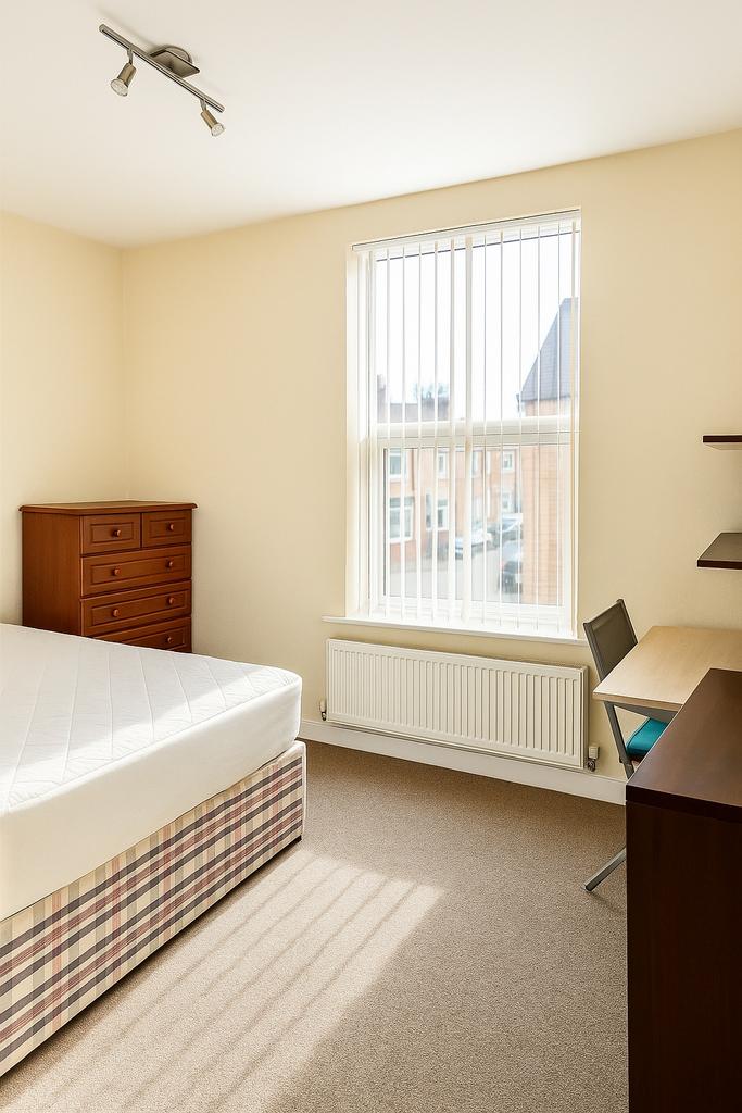 Bright, well-presented bedroom with a large win...