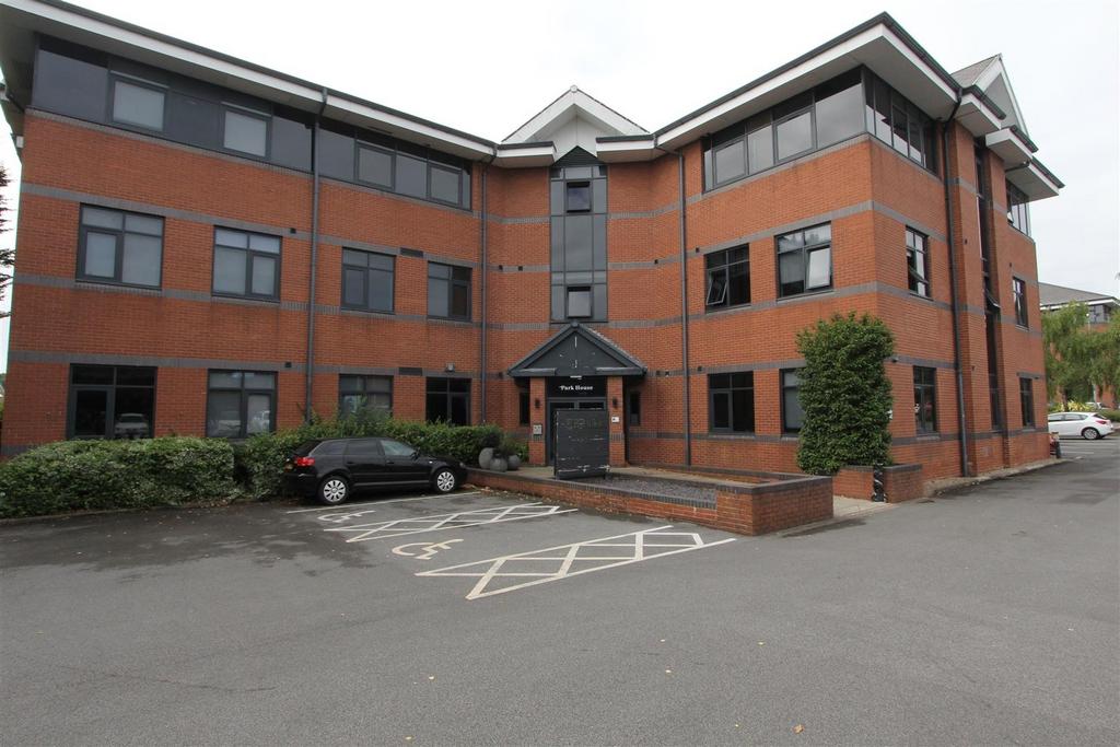 Modern brick building with ample parking space...