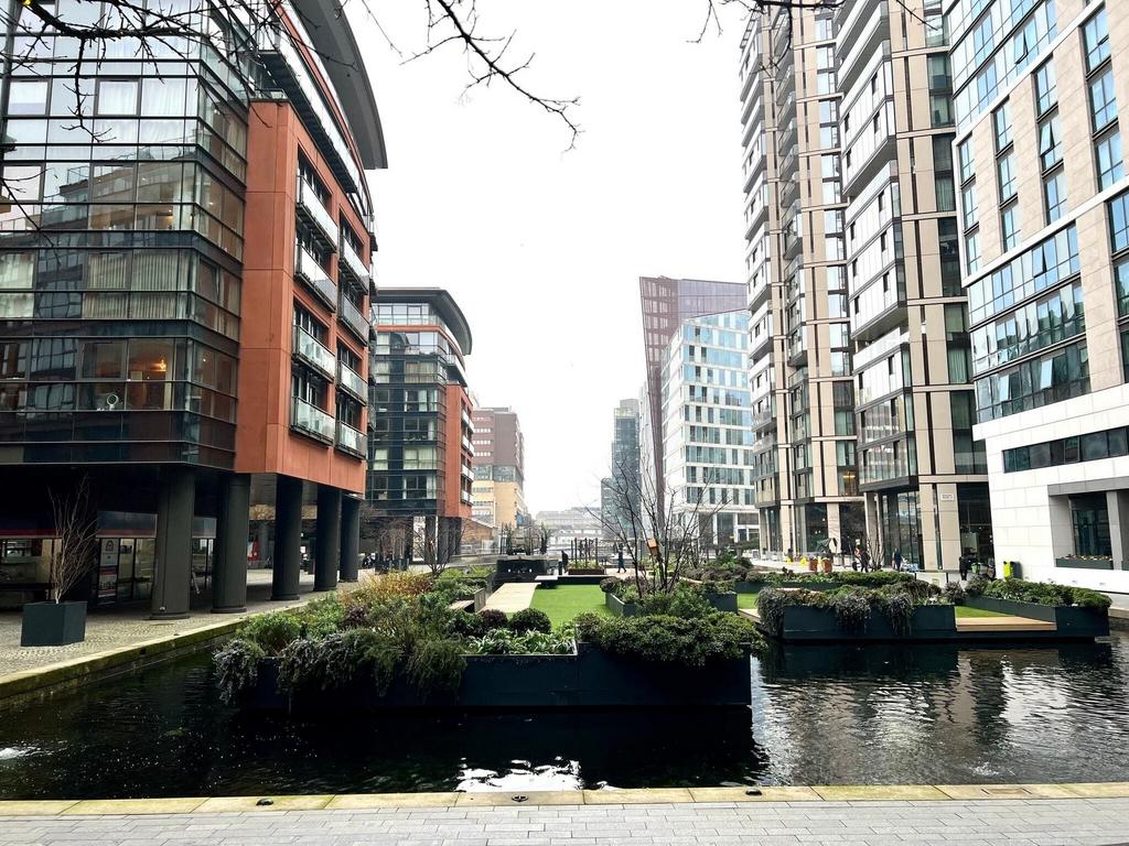 Modern urban plaza with lush floating gardens...