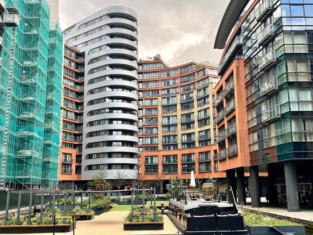 Modern urban complex with vibrant garden square...