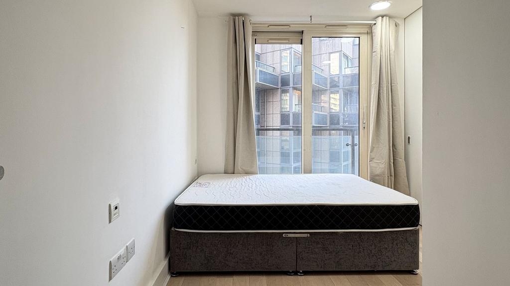 Bright modern bedroom with large window...