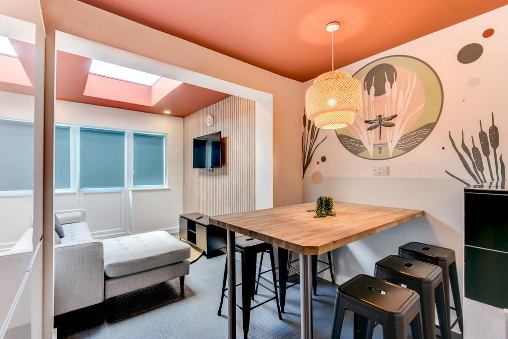 Bright, modern living area with a cosy chaise s...