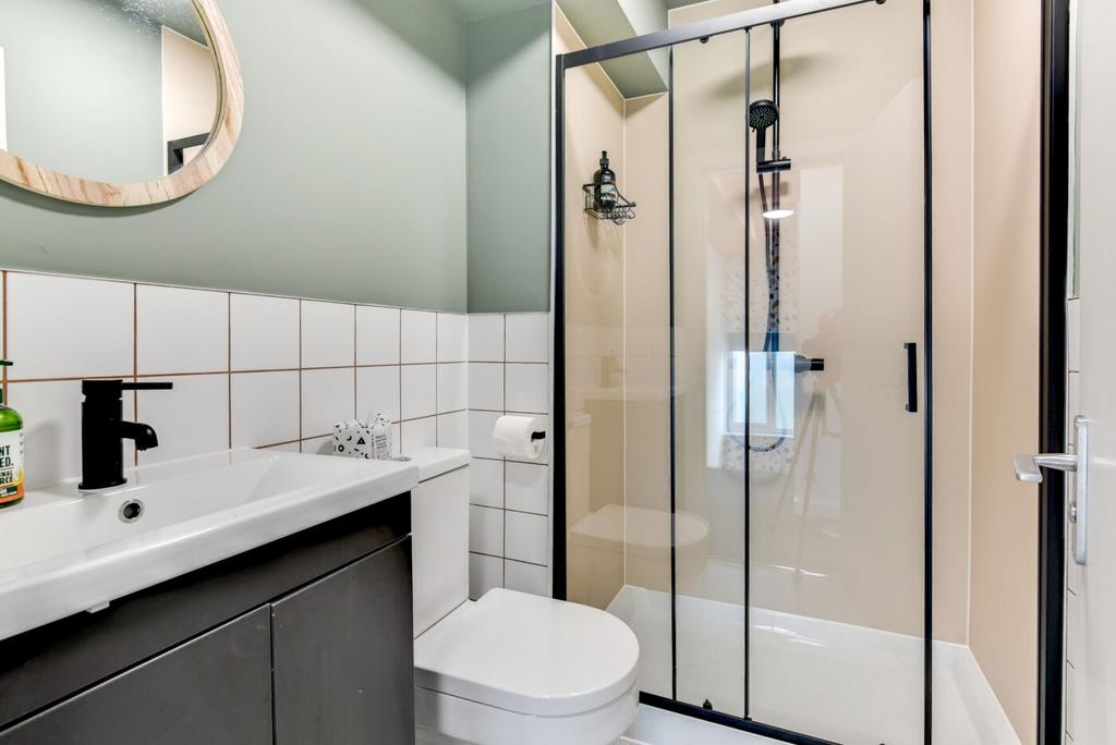 Modern ensuite bathroom with a walk-in shower f...
