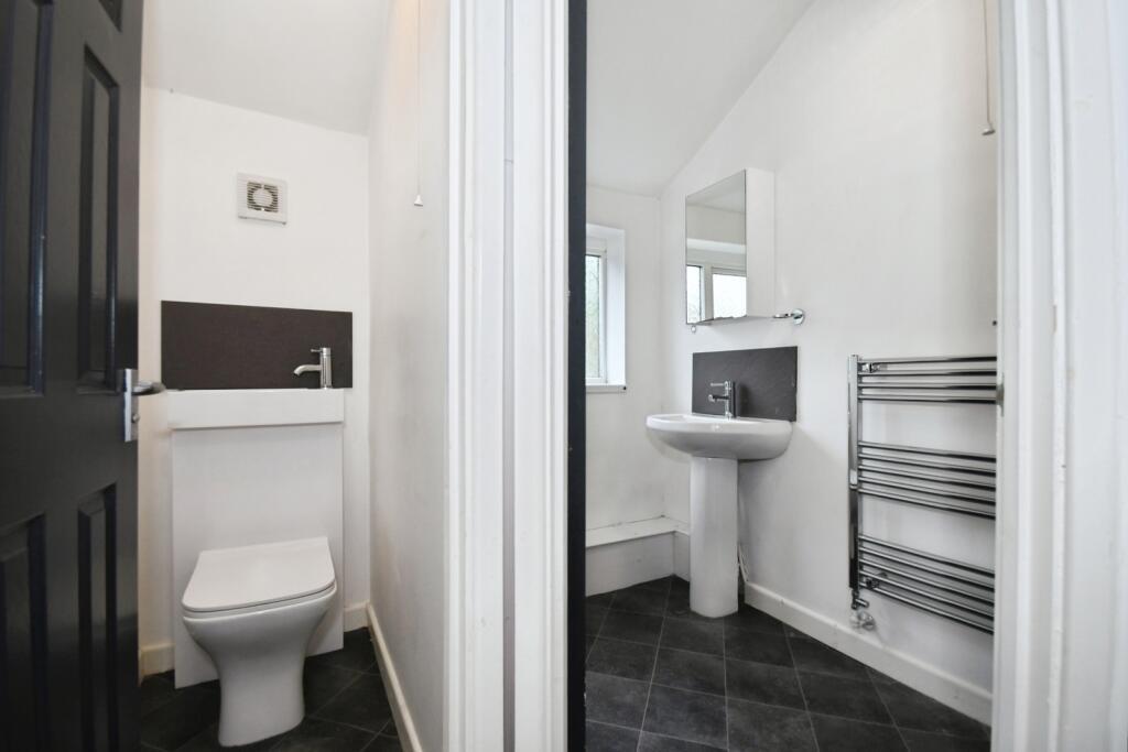 Bright, modern split bathroom area with crisp w...