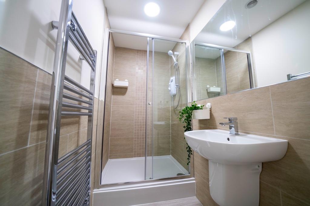 Modern bathroom with a glass-enclosed shower ar...