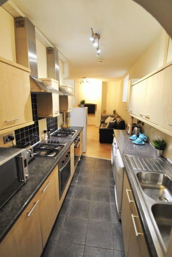 Modern galley kitchen with integrated appliance...