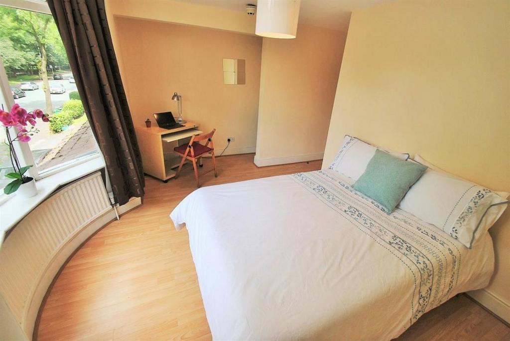 Bright master bedroom with a dedicated desk are...