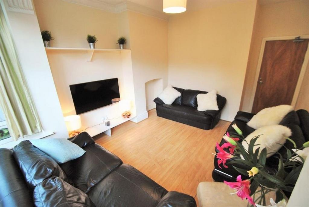 Bright lounge with leather sofas and large TV...