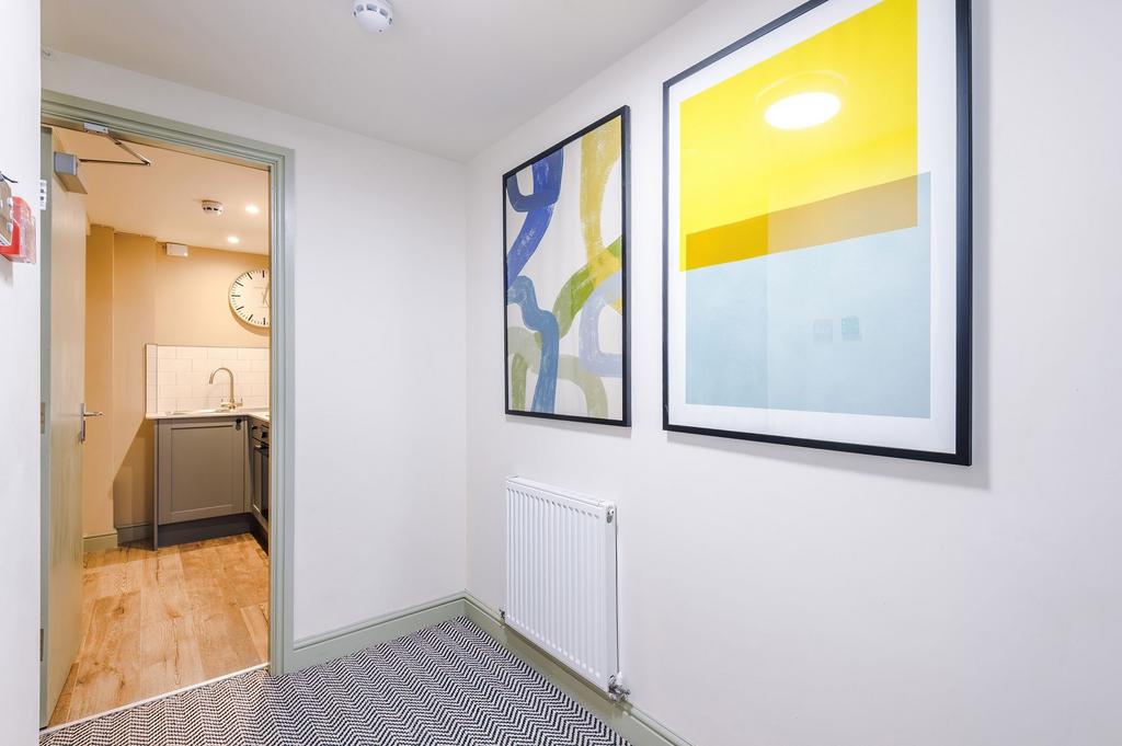 Bright, well-decorated hallway with modern artw...