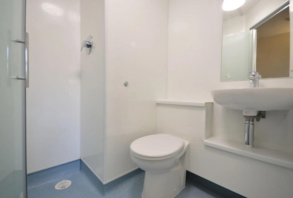 Bright, modern en-suite with sleek white finish...