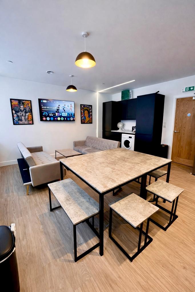 Bright shared lounge with dining table and seat...
