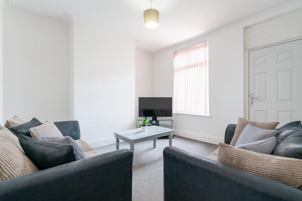 A bright, well-maintained living room featuring...