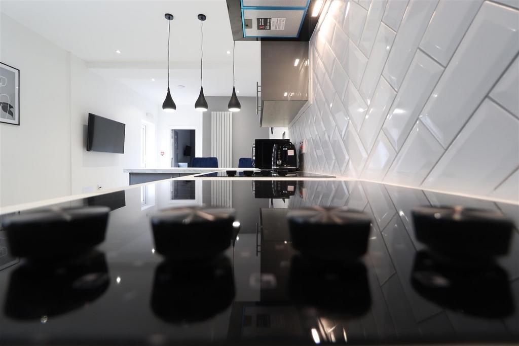 Modern kitchen with sleek tiles and smart hobs...