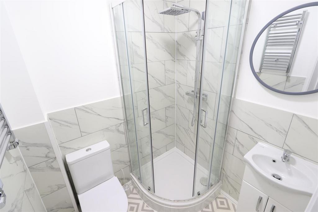 Modern tiled bathroom with rainfall shower...