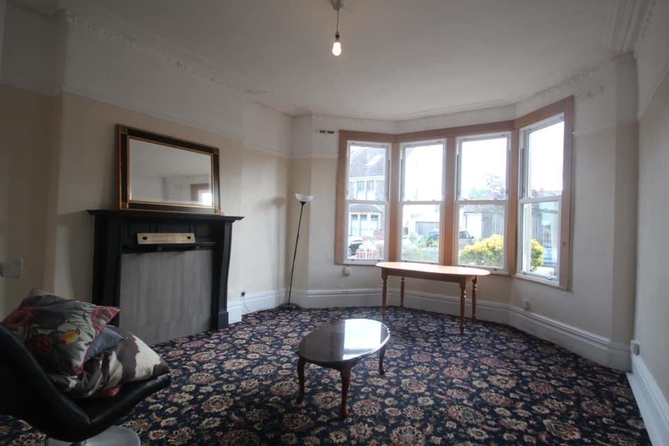 Spacious bright living room with large bay wind...