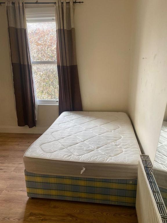 Bright bedroom with double bed and large window...