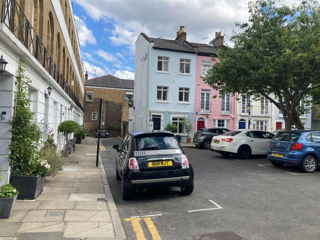 Street scene with property, parking