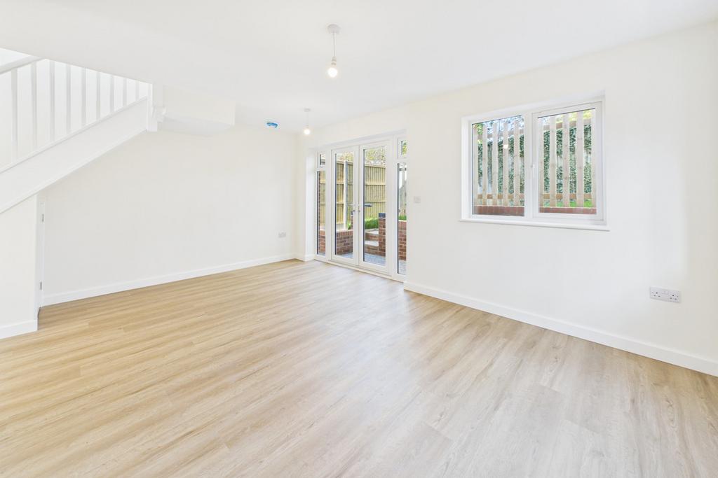 Light open-plan lounge and dining room with doors to the garden