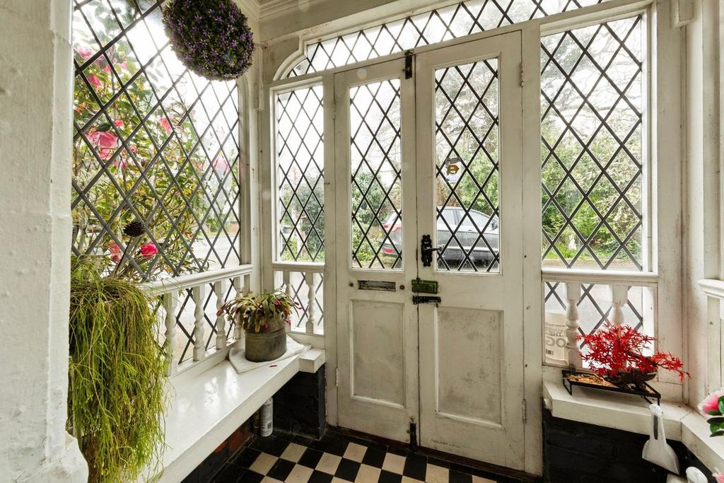 Conservatory interior, french doors leading to garden
