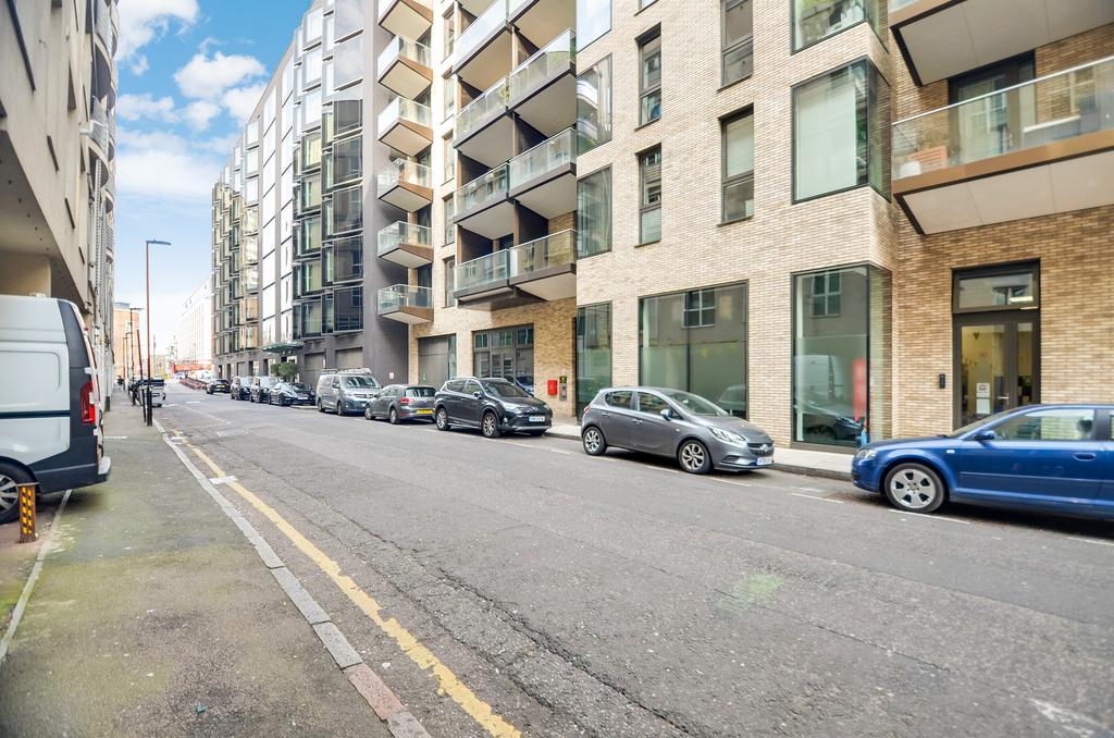 Street scene with property, parking