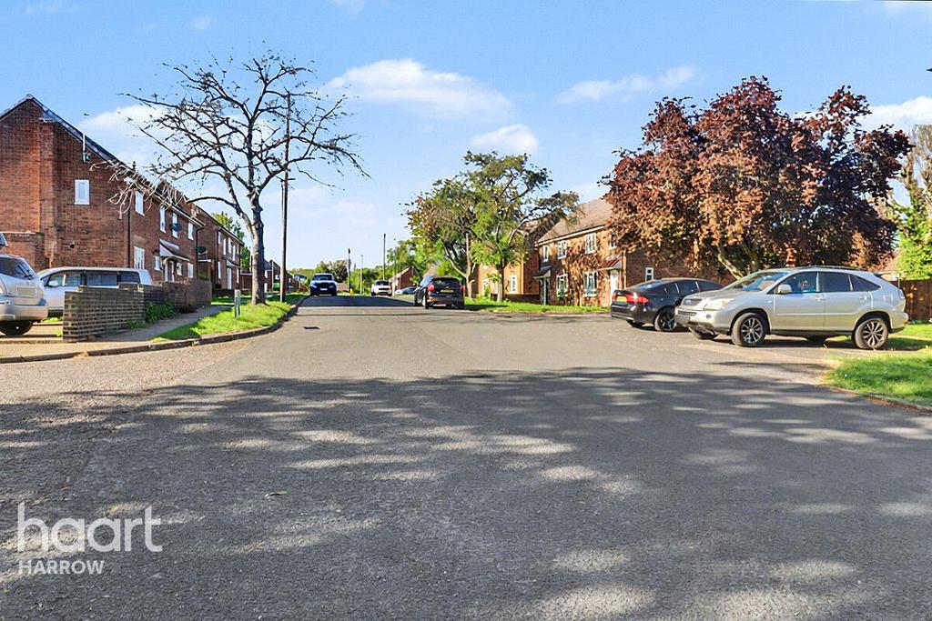Street scene with property, parking