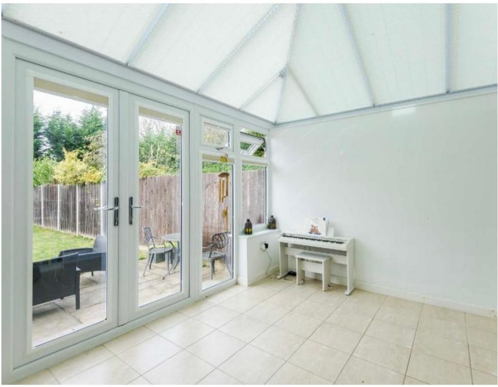 Conservatory interior, french doors leading to garden, conservatory