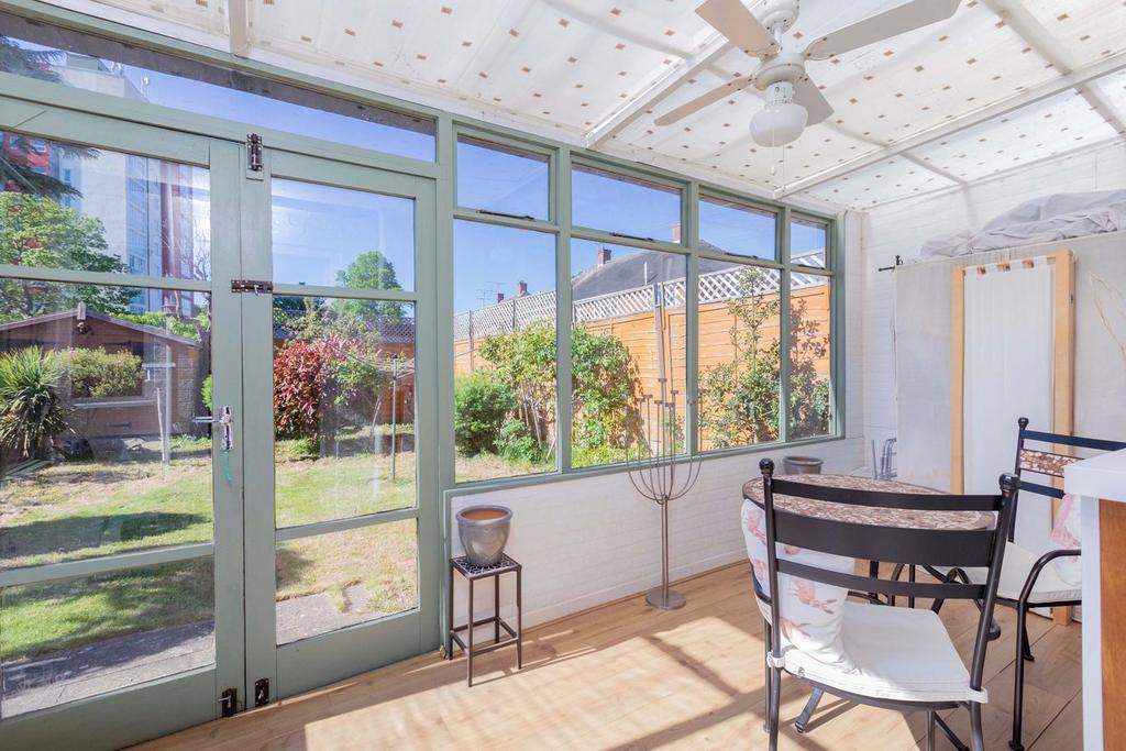 Conservatory interior, french doors leading to garden