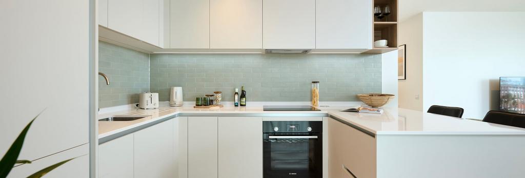 Kitchen with attached island, white panels and...