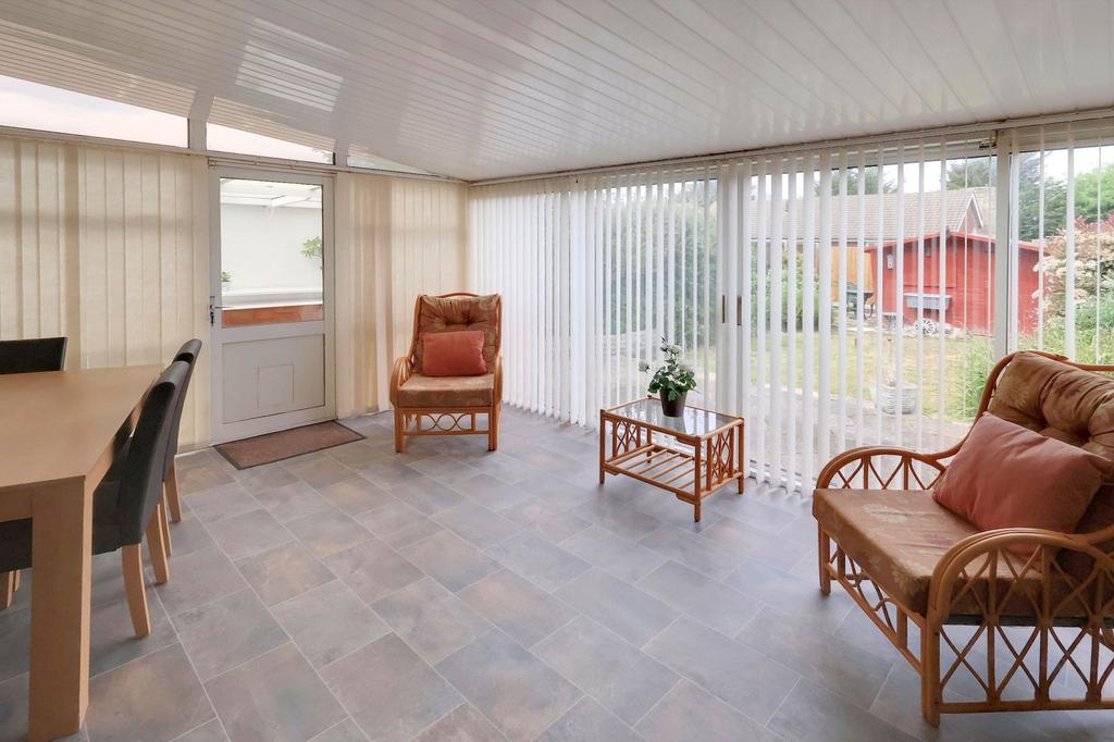 Conservatory interior, french doors leading to garden