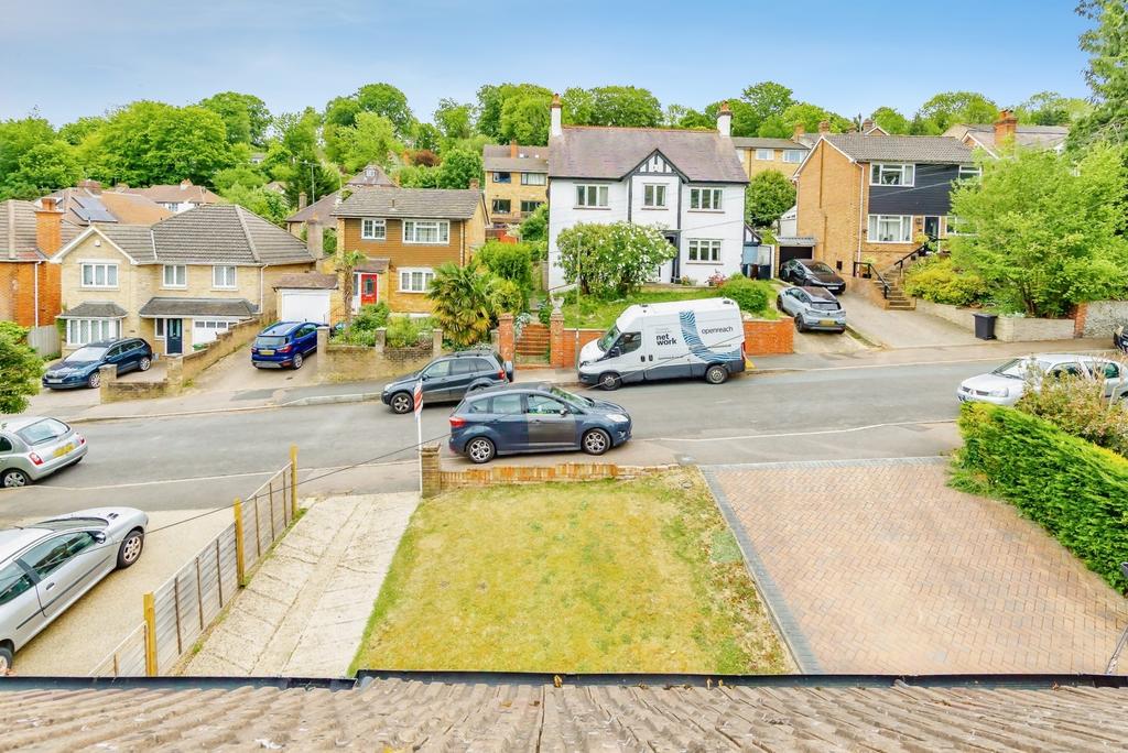Street scene with property, parking