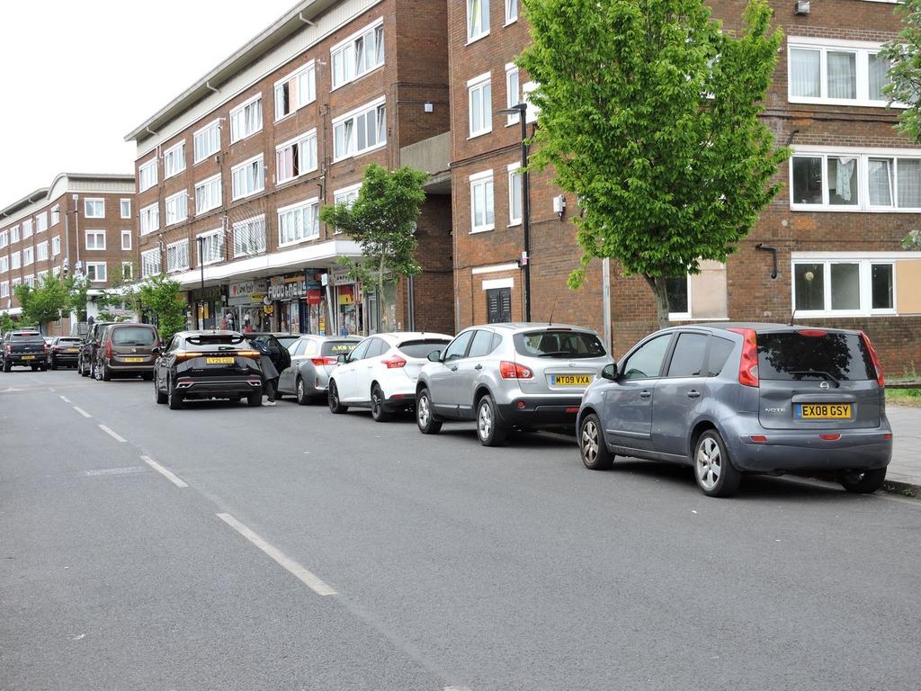 Street scene with property, parking