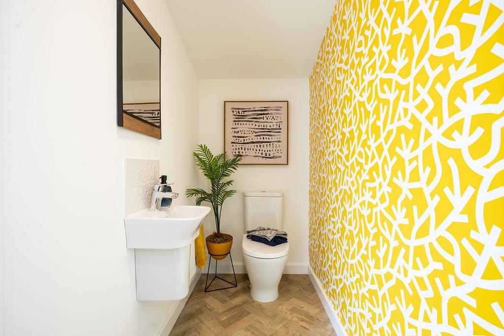 A small bathroom with a white toilet and sink,...