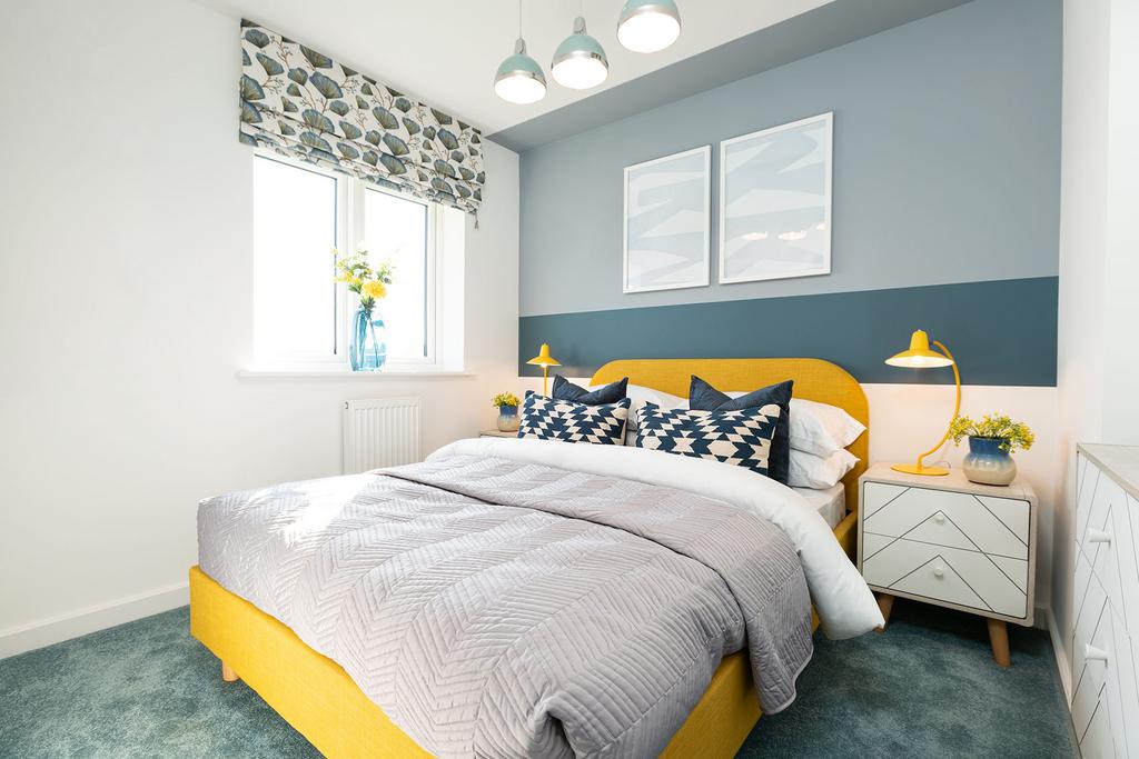 A cozy and vibrant bedroom with a yellow bed...