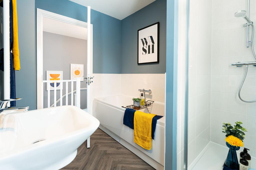 A modern bathroom with a white bathtub, blue...