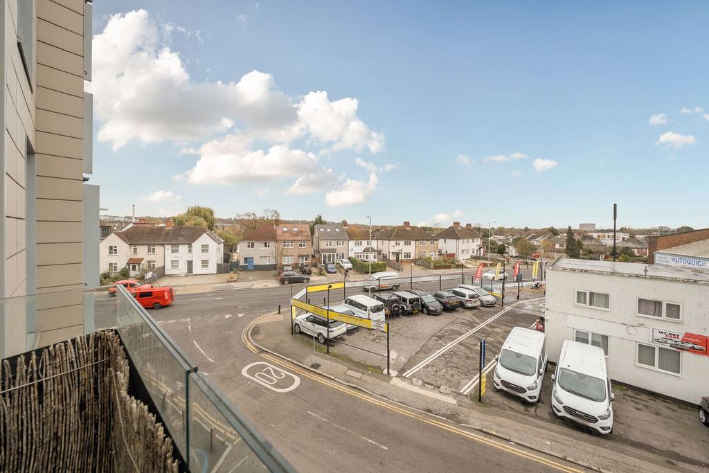 Street scene with property, parking