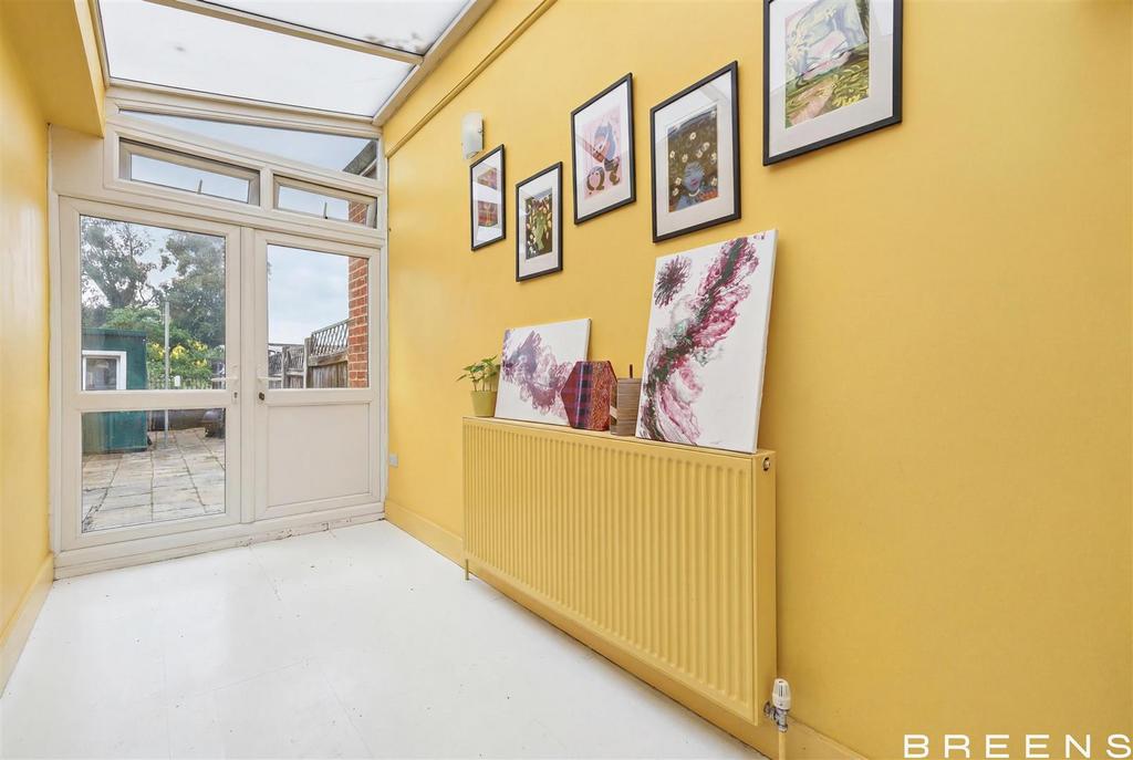 Conservatory interior, french doors leading to garden