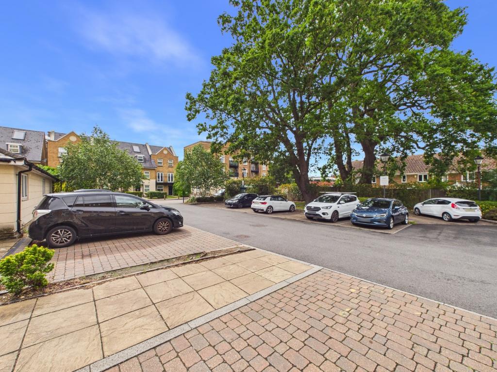 Street scene with property, parking
