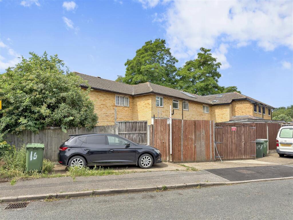 Street scene with property, parking