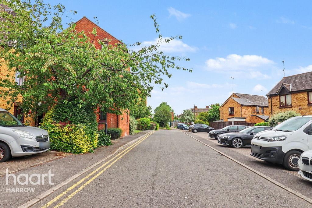 Street scene with property, parking