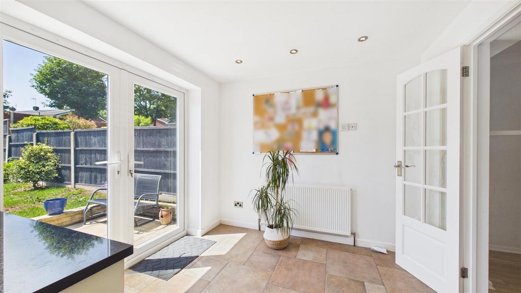 Conservatory interior, french doors leading to garden