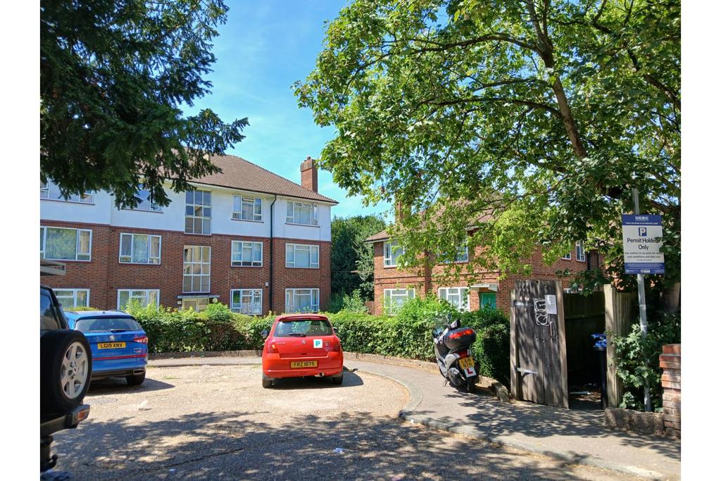 Street scene with property, parking