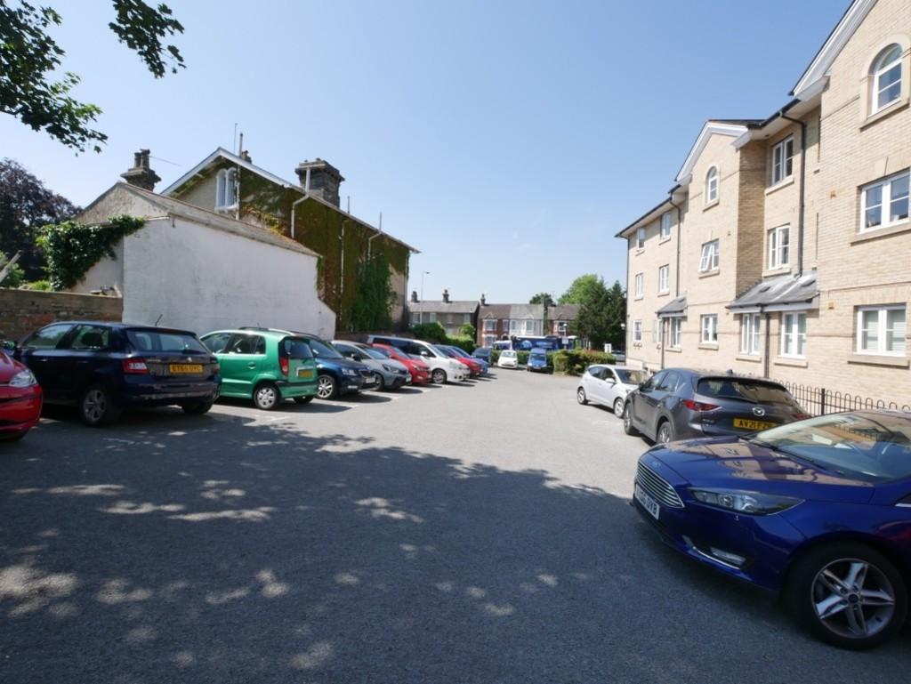 Street scene with property, parking
