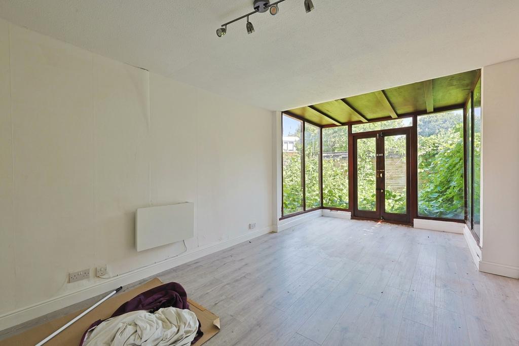 Conservatory interior, french doors leading to garden