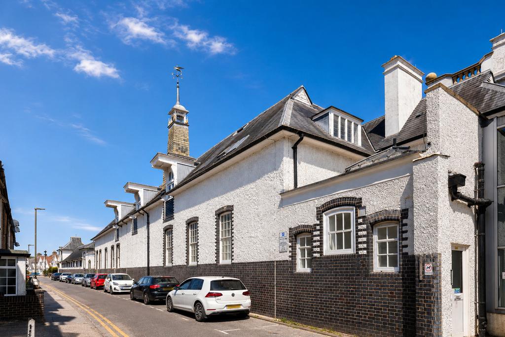 Street scene with property, parking