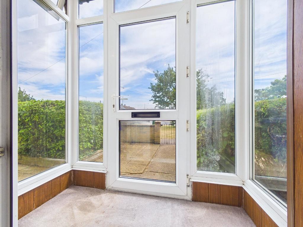 Conservatory interior, french doors leading to garden